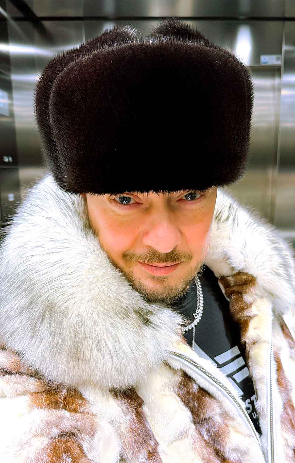 man wearing original Soviet naval officer fur hat with black mink