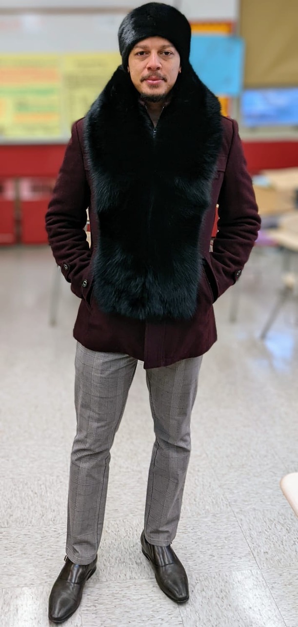 man wearing black fox fur collar and matching fur hat