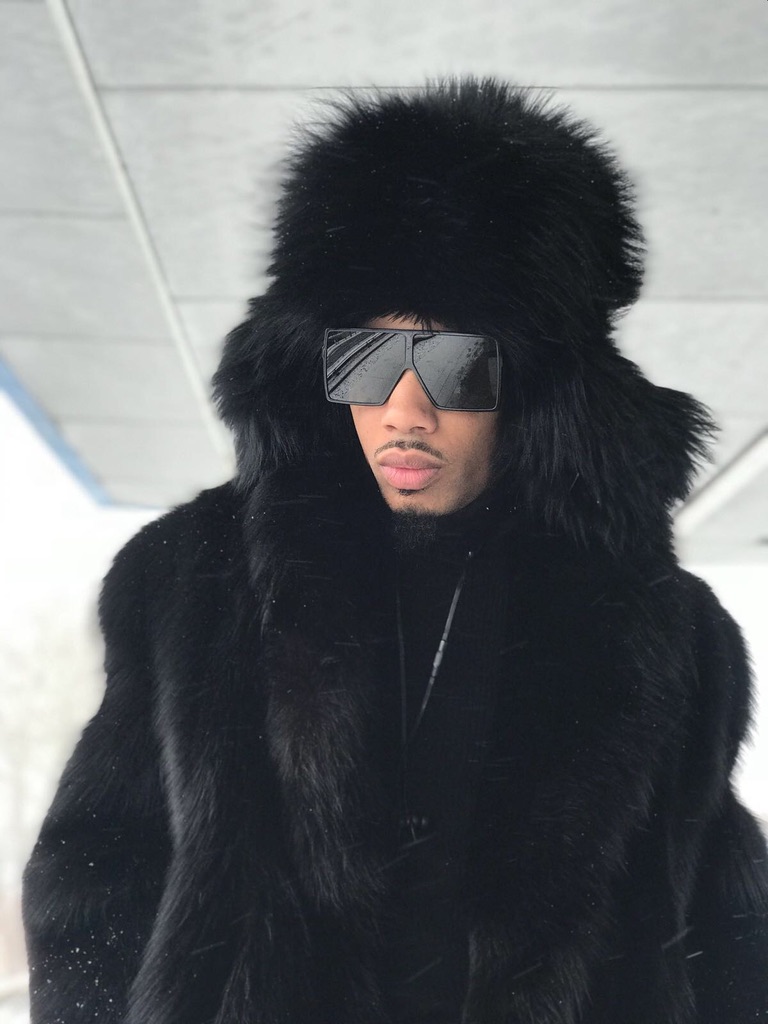 man wearing black raccoon fur ushanka hat