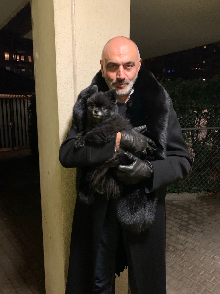 man wearing black fox fur stole around neck