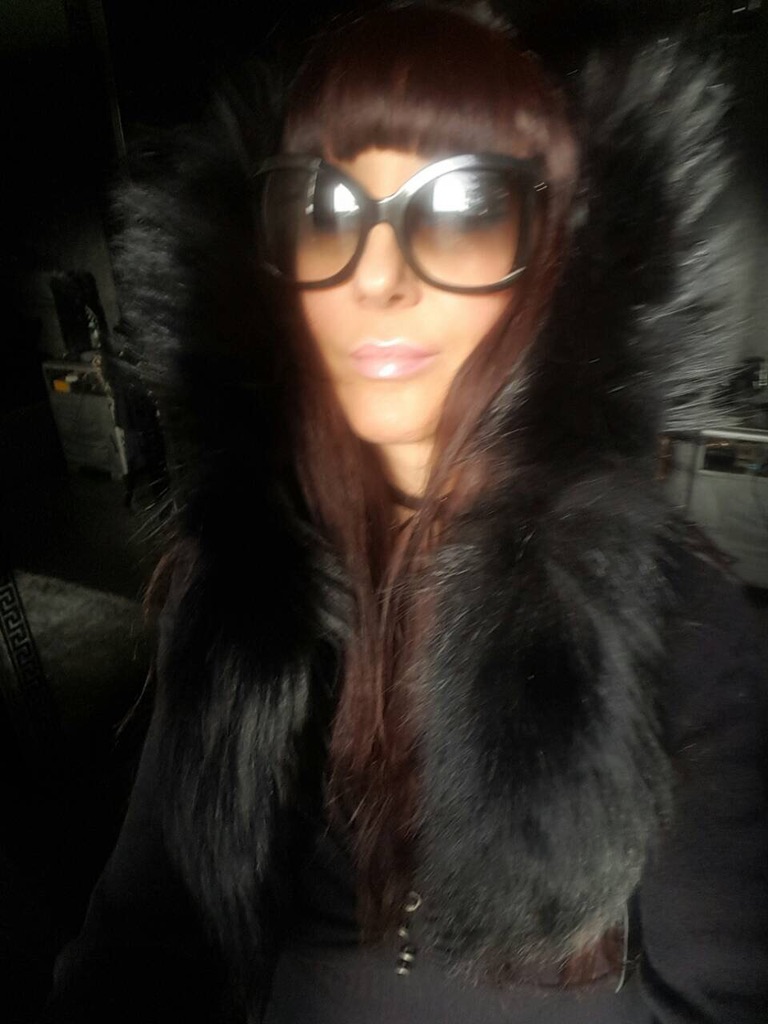 woman wearing black raccoon fur eskimo hood with tails