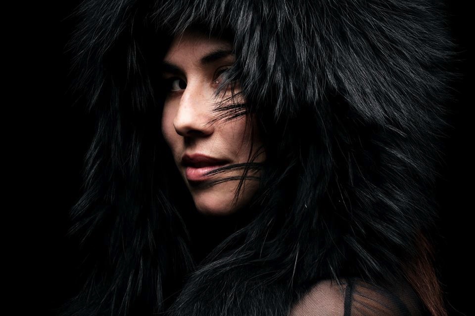 woman wearing black raccoon fur eskimo hood with tails