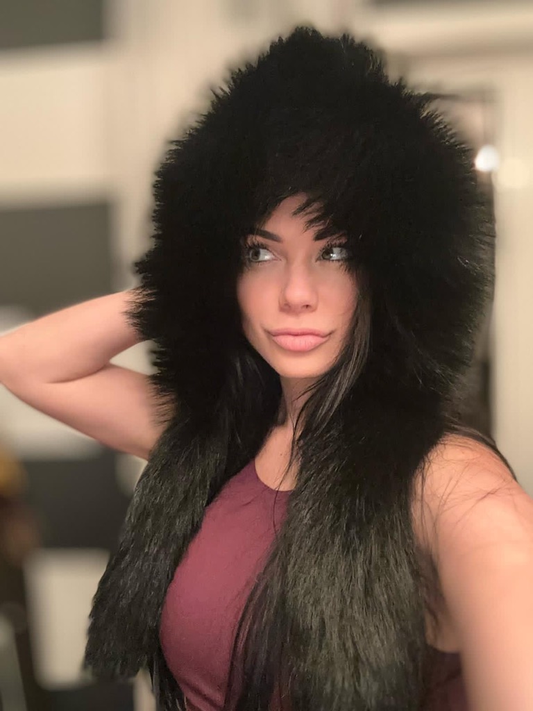 woman wearing black raccoon fur hood with tails