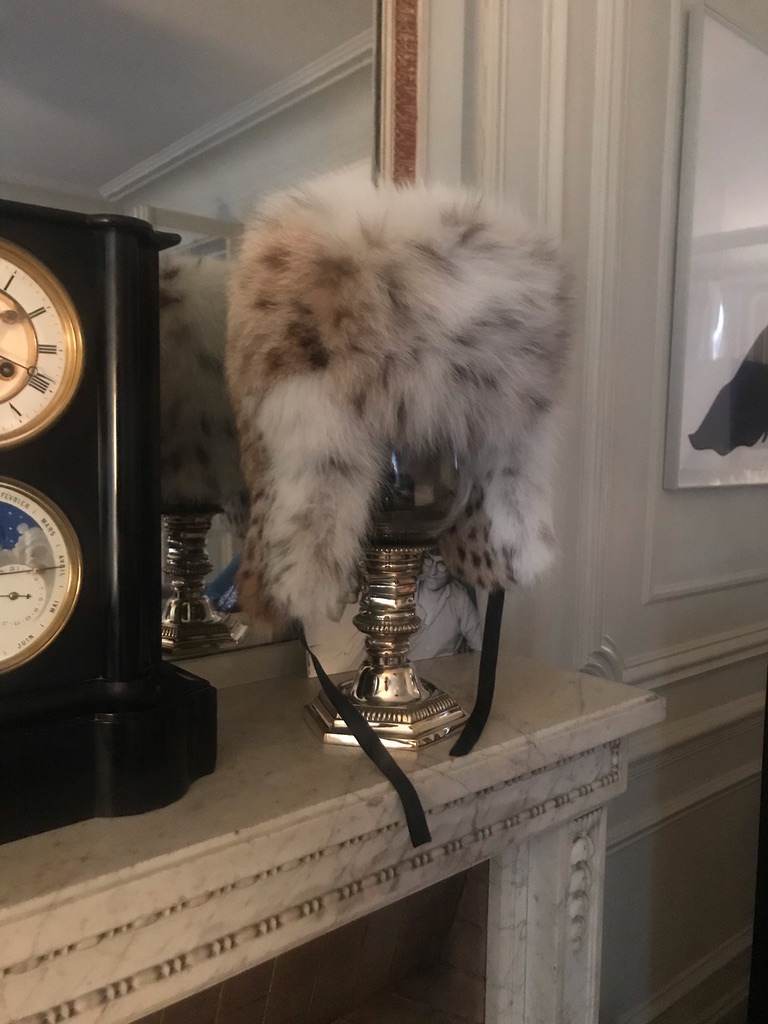 man holding or gifting luxury Russian lynx fur ushanka hat