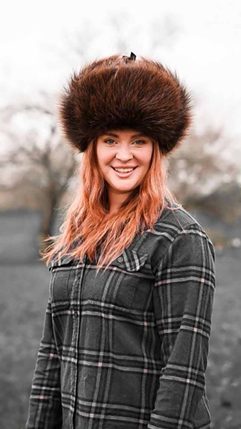 woman wearing golden beaver fur ushanka hat inherited from her father