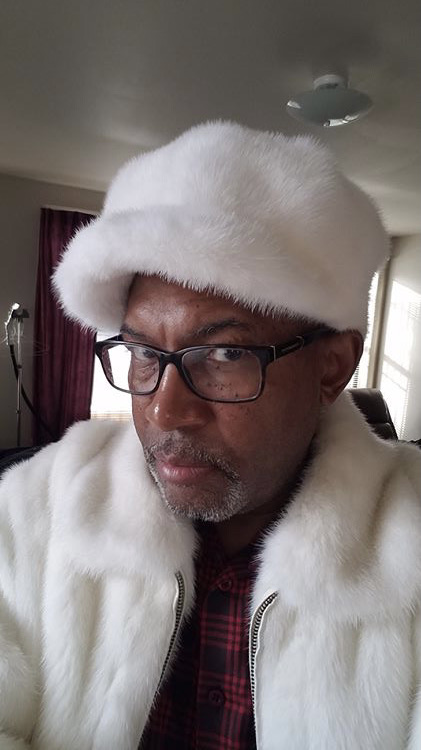 man wearing white mink fur newsboy cap