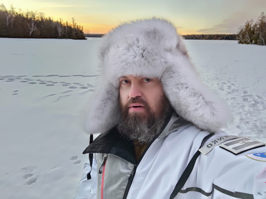 man wearing Siberian ushanka hat with blue polar fox fur