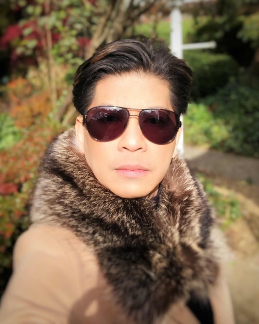 man wearing Canadian raccoon fur collar